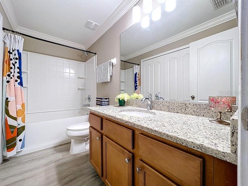 37615 Daliha Terrace Zephyrhills, FL 33542 - Photo 11 of 16 a bathroom with a granite countertop sink toilet and shower
