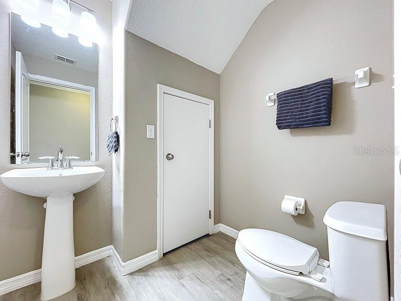 37615 Daliha Terrace Zephyrhills, FL 33542 - Photo 14 of 16 a bathroom with a sink toilet mirror and vanity