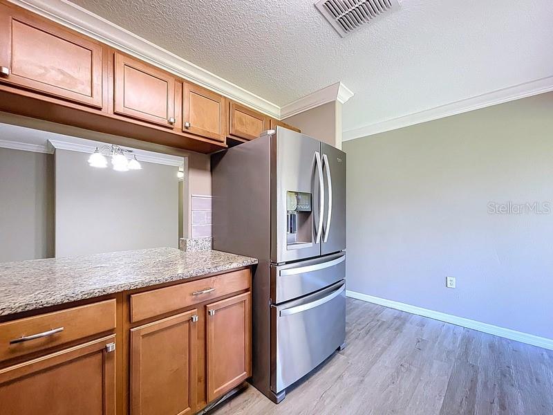 37615 Daliha Terrace Zephyrhills, FL 33542 - Photo 6 of 16 a kitchen with stainless steel appliances granite countertop a refrigerator and a sink