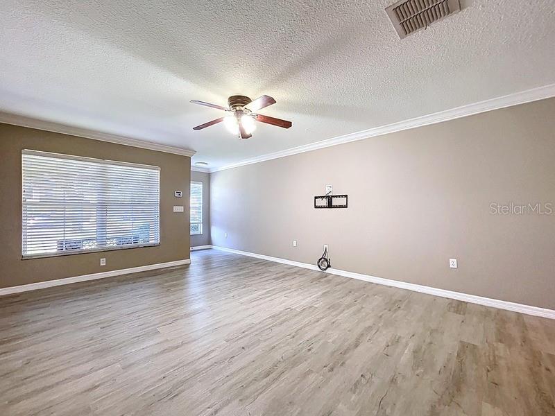 37615 Daliha Terrace Zephyrhills, FL 33542 - Photo 7 of 16 a view of an empty room with a window and wooden floor
