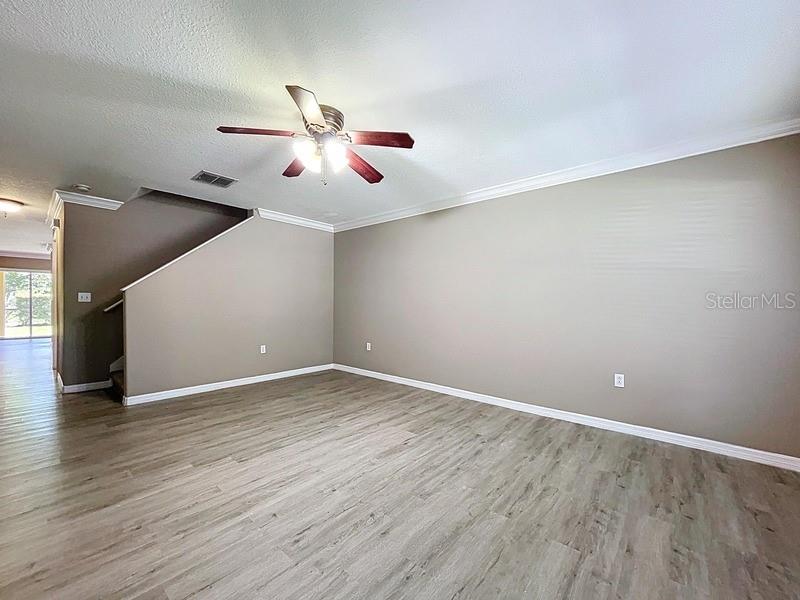 37615 Daliha Terrace Zephyrhills, FL 33542 - Photo 8 of 16 a view of an empty room with wooden floor