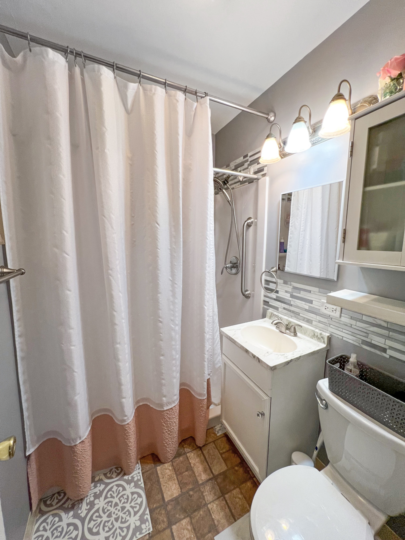 1926 Chippewa Road Waukegan, IL 60087 - Photo 6 of 13 a bathroom with a sink a toilet and shower
