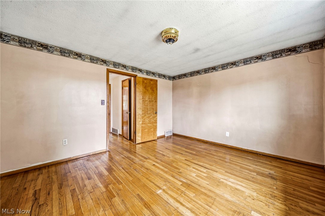 1694 Ridgewick Drive Wickliffe, OH 44092 - Photo 17 of 30 Hardwood flooring throughout, neutral wall paint, and a textured ceiling