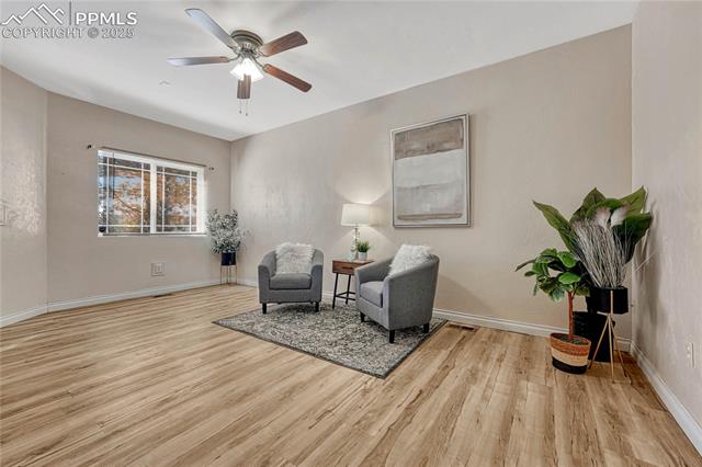 1502 York Road, Unit 102 Colorado Springs, CO 80920 - Photo 3 of 29 Sitting room with a ceiling fan, baseboards, and wood finished floors
