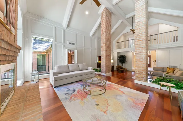a kitchen with stainless steel appliances granite countertop a sink and wooden floors