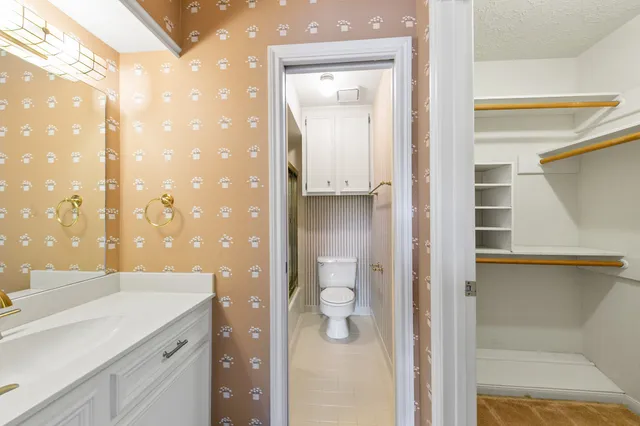 an empty room with windows and cabinet