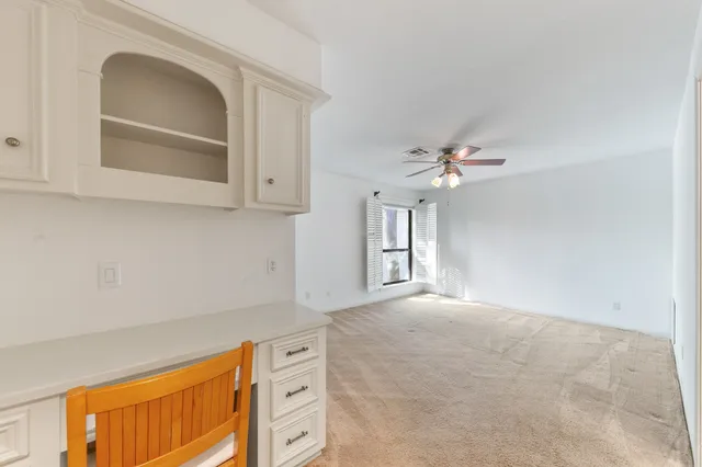 a spacious bathroom with a double vanity sink a mirror and a shower