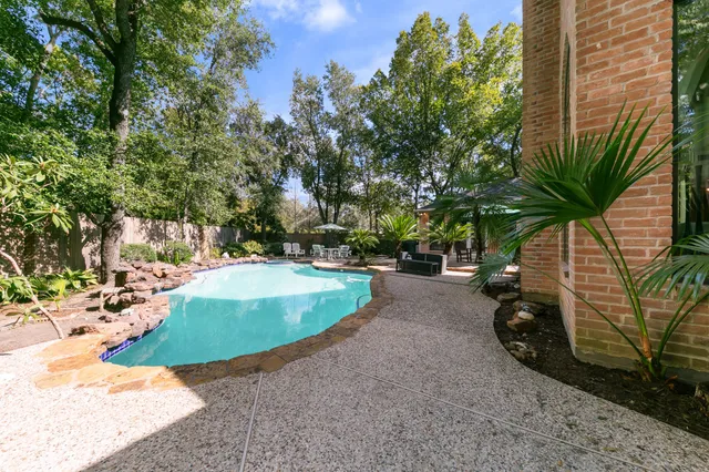an aerial view of a house with a yard and garden