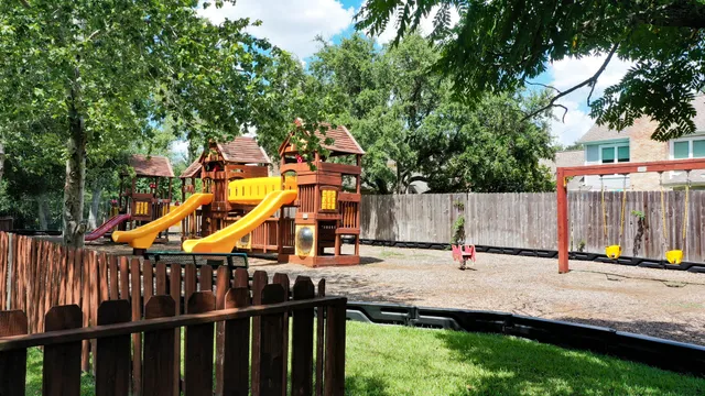 a backyard of a house with table and chairs
