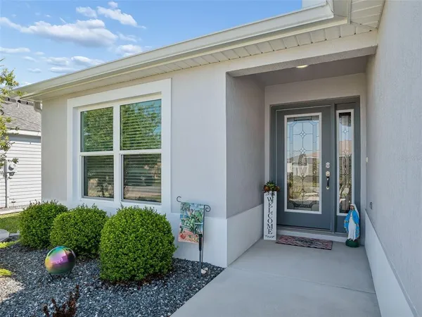 a kitchen with stainless steel appliances granite countertop a sink a stove a refrigerator cabinets and a dining table