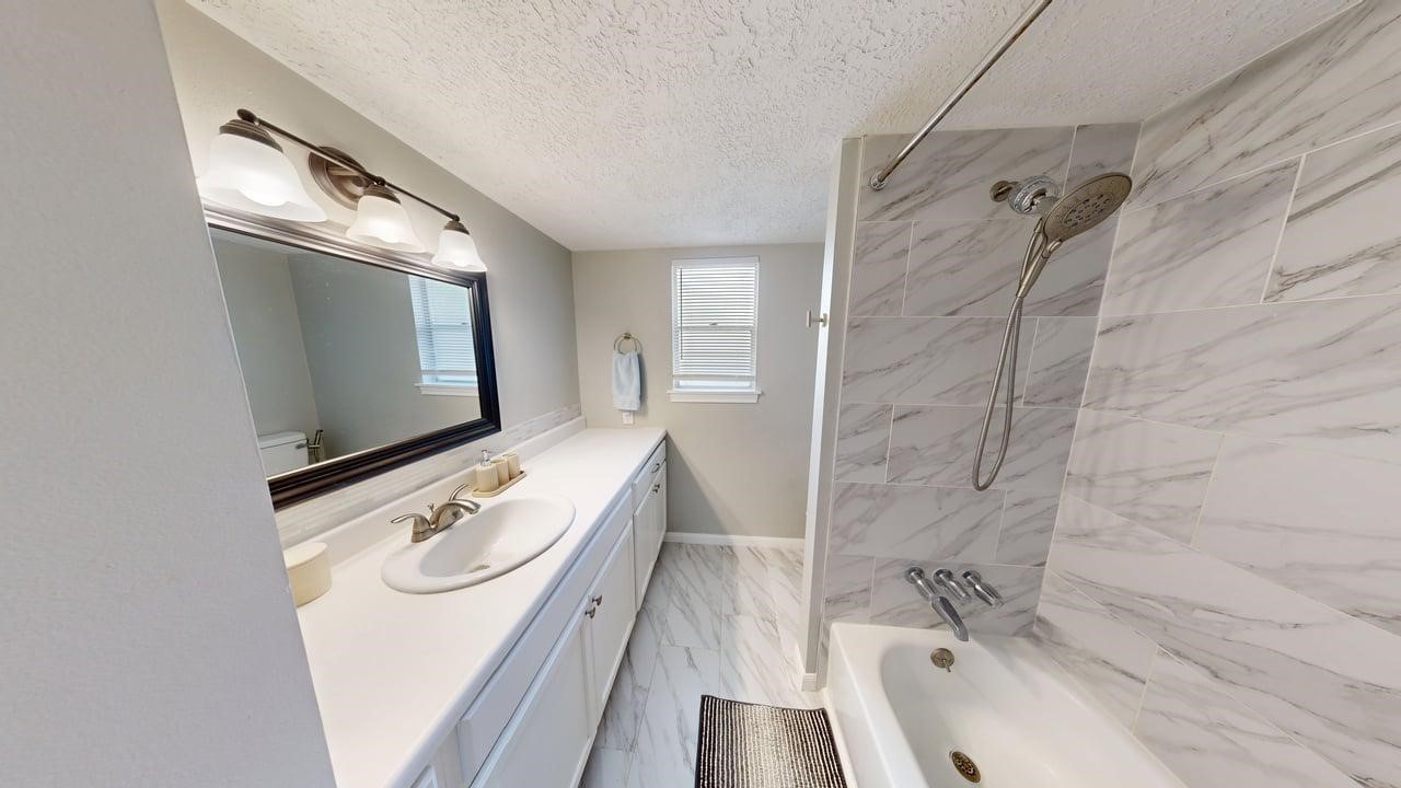 619 Cotter Drive Spring, TX 77373 - Photo 37 of 50 a bathroom with a sink a mirror and a bathtub