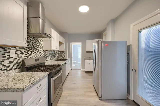 a kitchen with a sink a stove and refrigerator