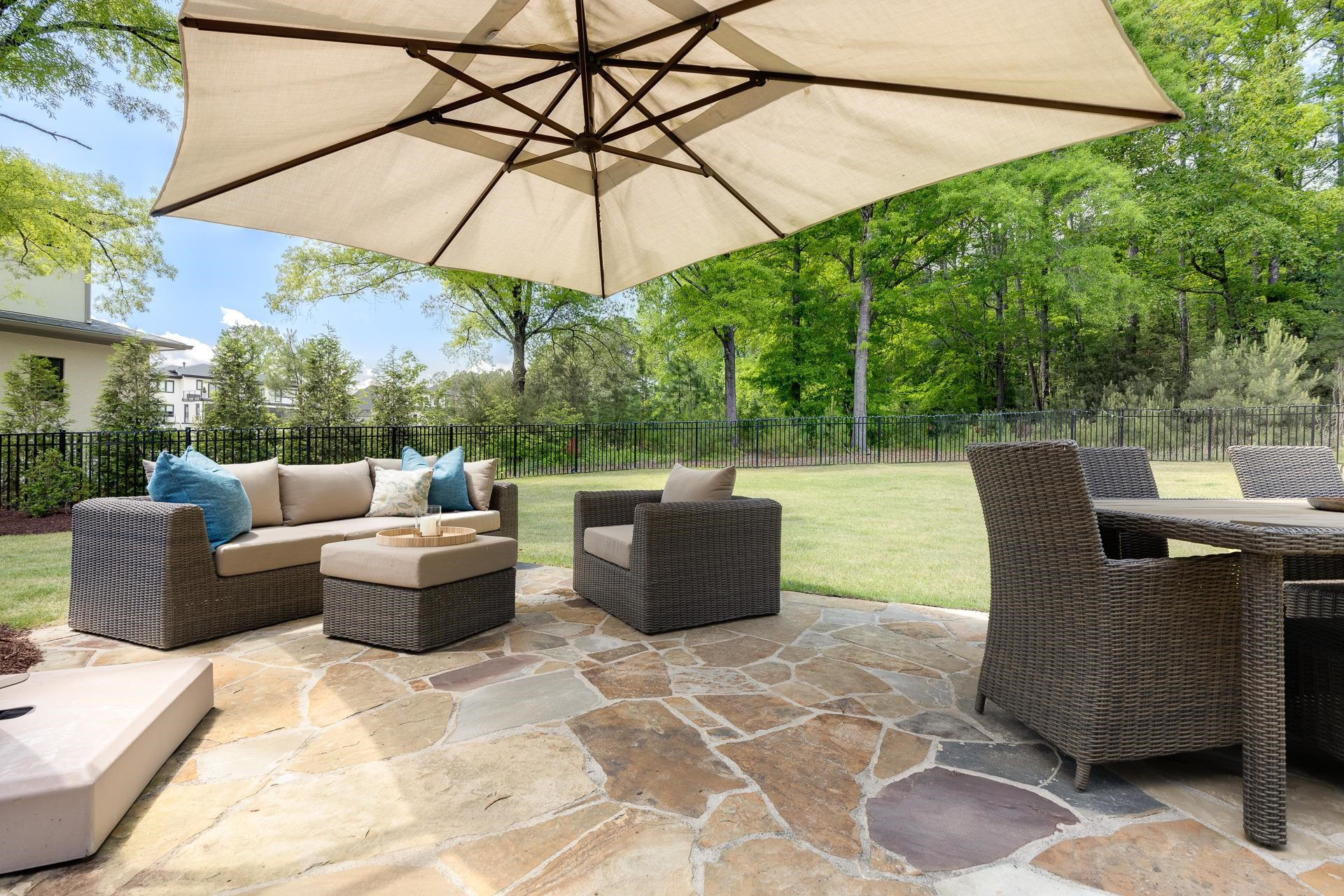 116 Turner Ridge Circle Durham, NC 27713 - Photo 57 of 63 a view of a patio with couches chairs under an umbrella