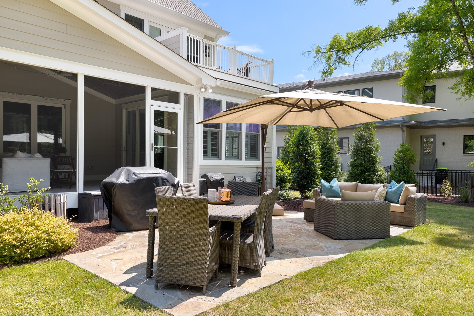 116 Turner Ridge Circle Durham, NC 27713 - Photo 58 of 63 a view of a patio with couches table and chairs under an umbrella