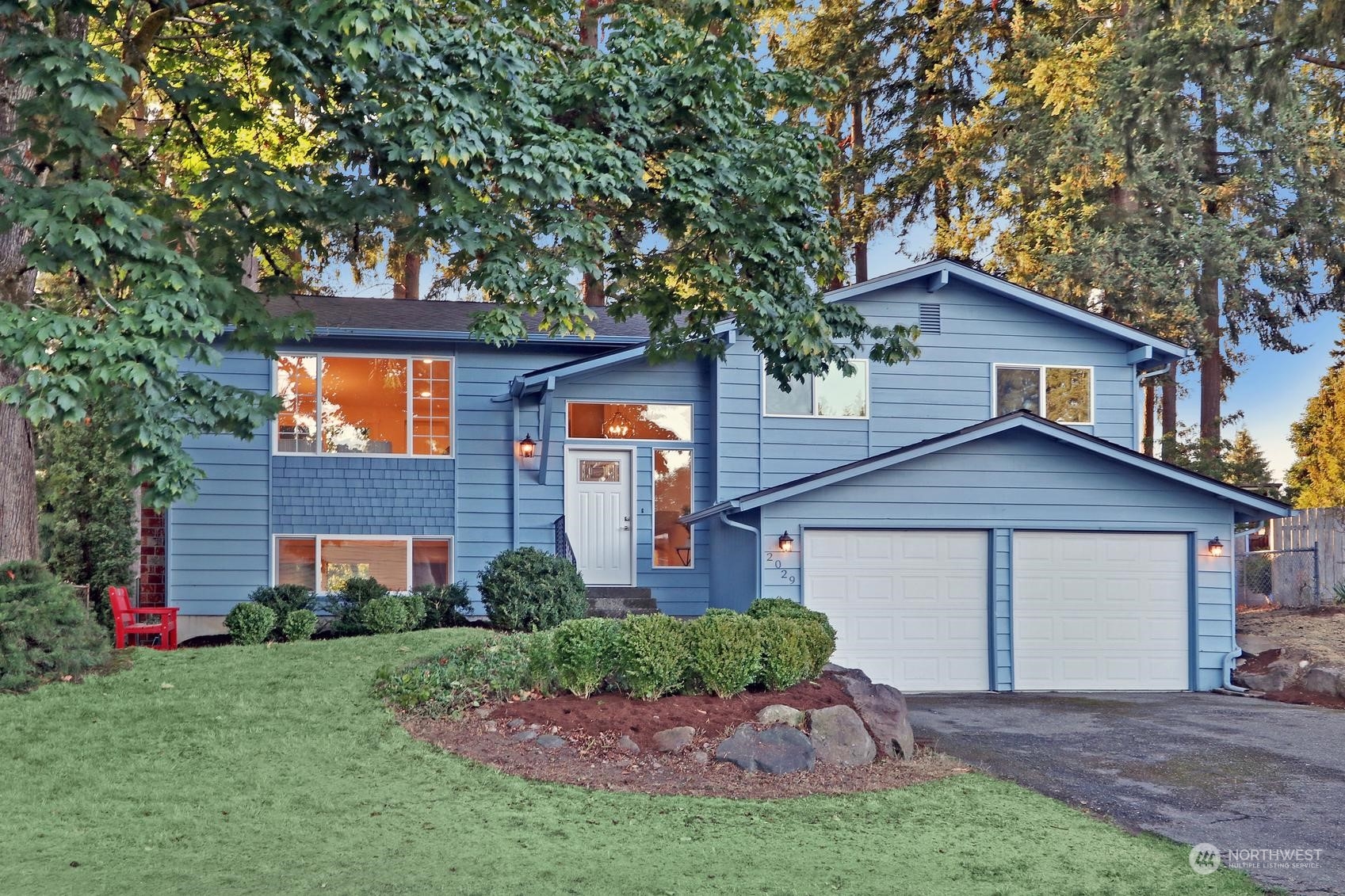 2029 Timber Trail Bothell, WA 98012 - Photo 1 of 24 a front view of a house with a garden and trees