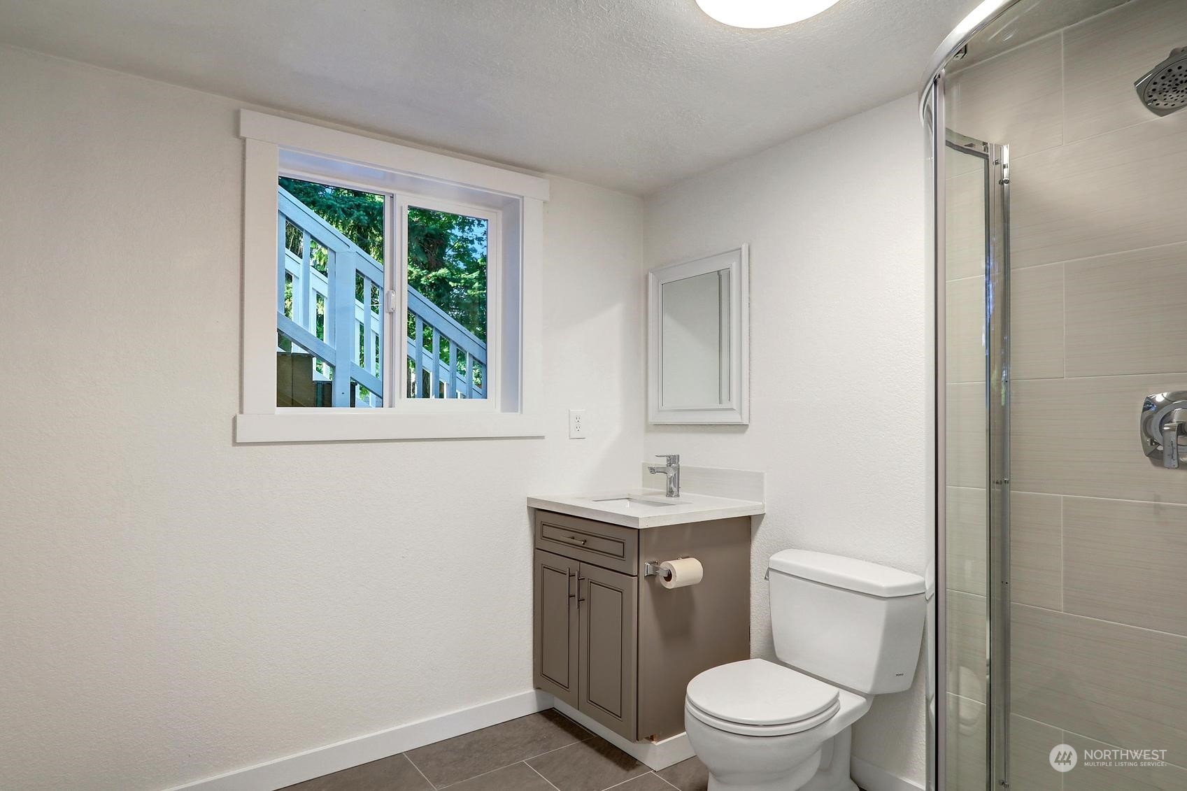 2029 Timber Trail Bothell, WA 98012 - Photo 18 of 24 a bathroom with a toilet a sink a vanity and mirror