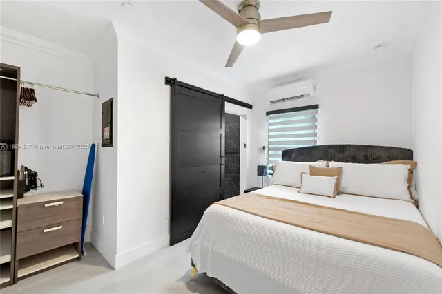 a bedroom with a bed and a mirror