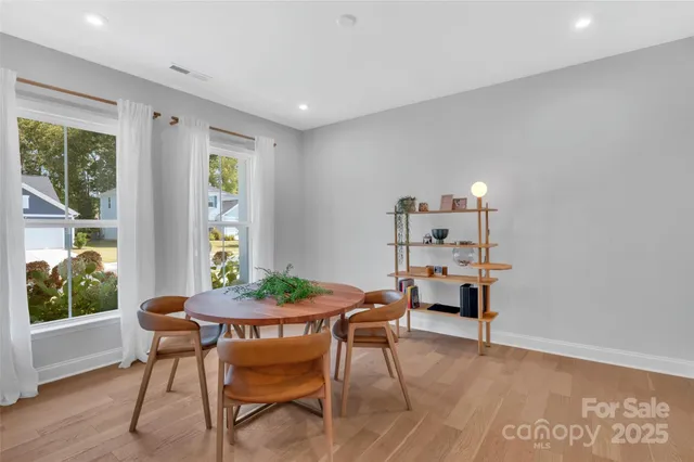 a view of a dining room with furniture window and wooden floor