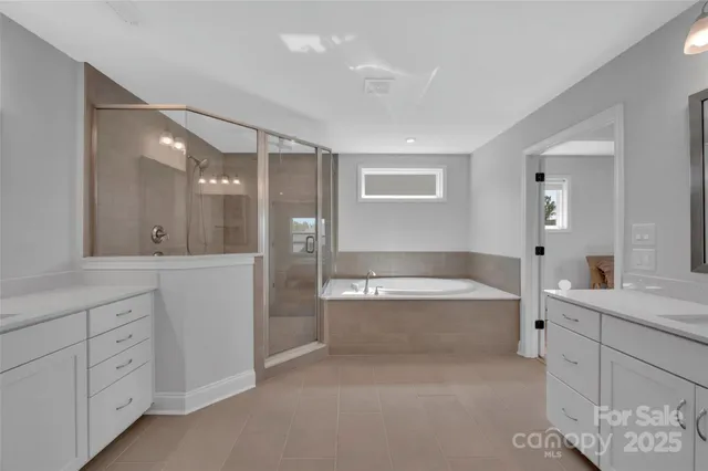 a bathroom with a tub sink and mirror