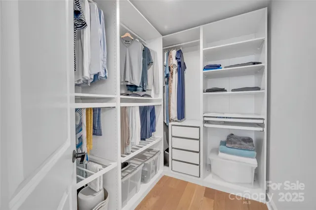 a view of walk in closet with empty racks