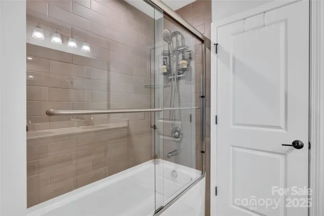a bathroom with a shower and a bath tub