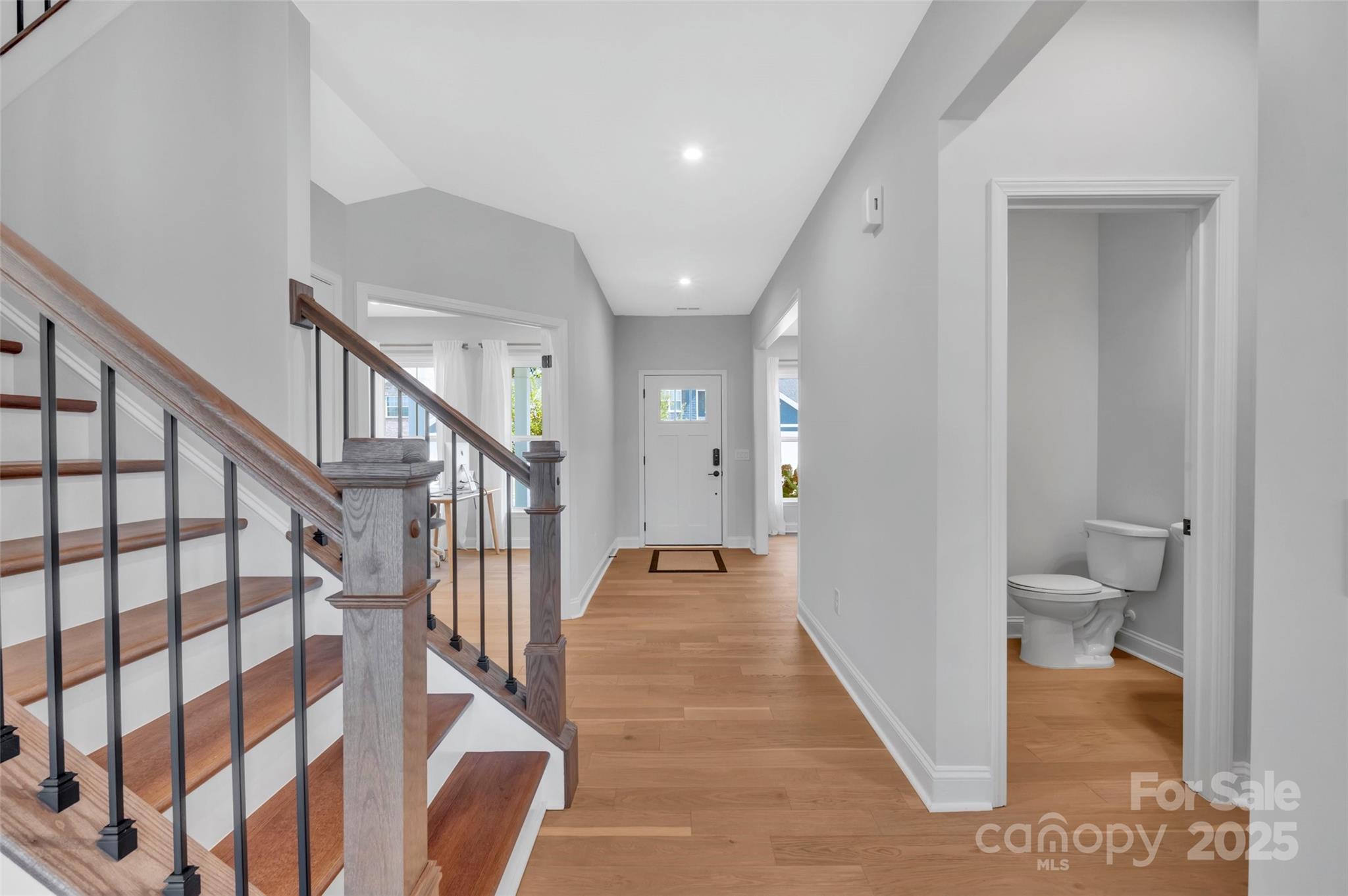 1185 Regions Boulevard Indian Land, SC 29707 - Photo 3 of 41 a view of a hallway with wooden floor and stairs