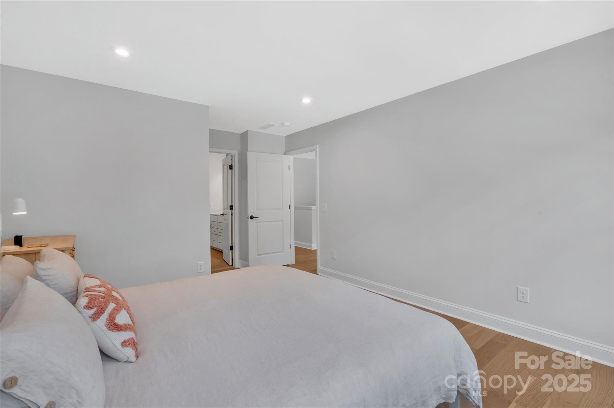 1185 Regions Boulevard Indian Land, SC 29707 - Photo 32 of 41 a bedroom with a large bed and a chandelier