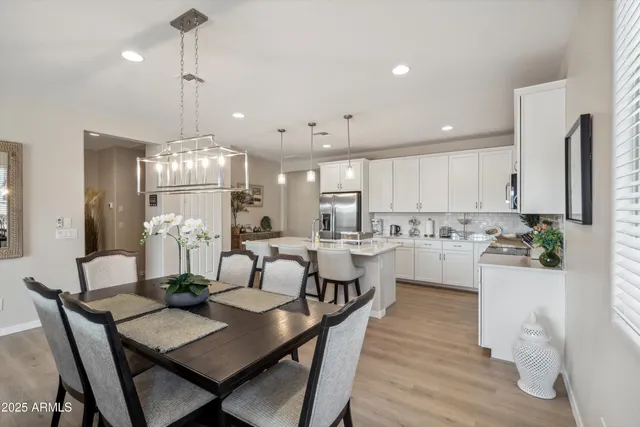a large kitchen with a table and chairs