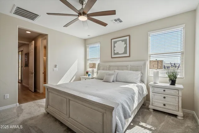 a bedroom with a large bed and a chandelier