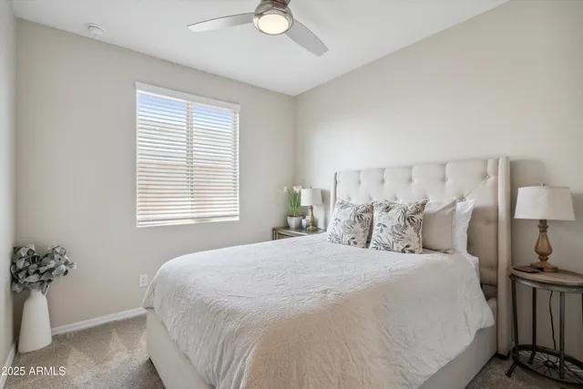 a bedroom with a large bed and a potted plant