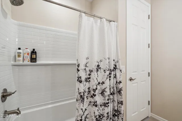 a bathroom with a shower curtain and a sink