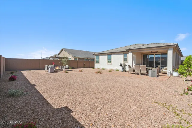 a view of house with yard and outdoor seating