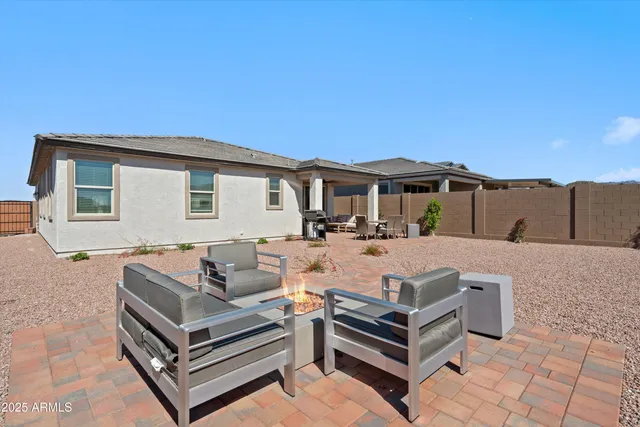a view of a house with a bed and a table