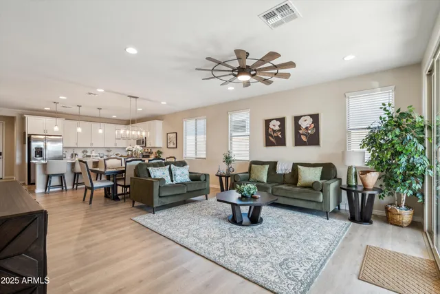 a living room with furniture and view of kitchen