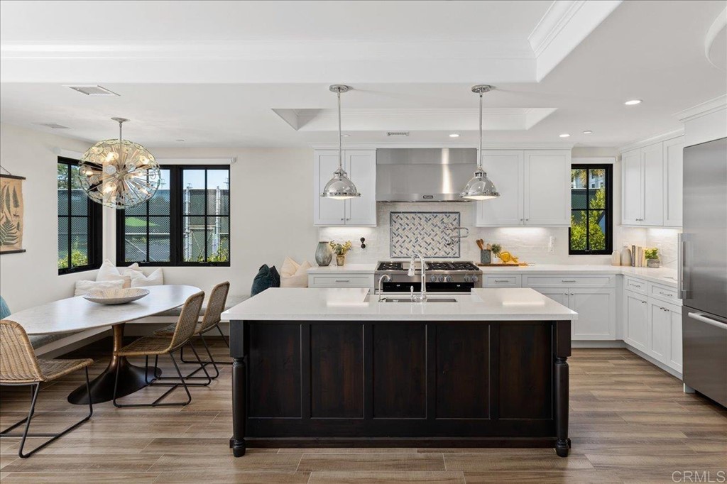 a kitchen with a table chairs and wooden floor