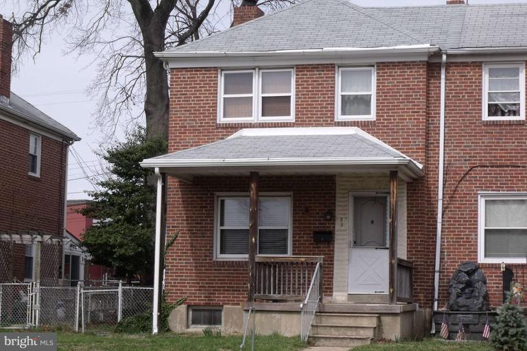 23 Hawthorne Road Baltimore, MD 21220 - Photo 1 of 1 a view of brick house with large windows and a small yard