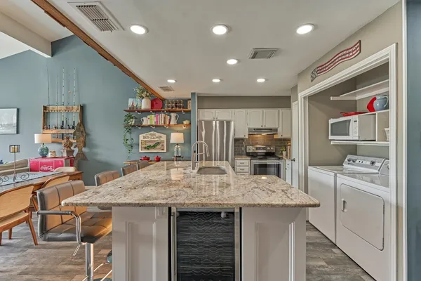 a kitchen with stainless steel appliances a stove and a refrigerator