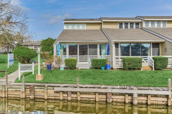 a house with a bench next to a yard