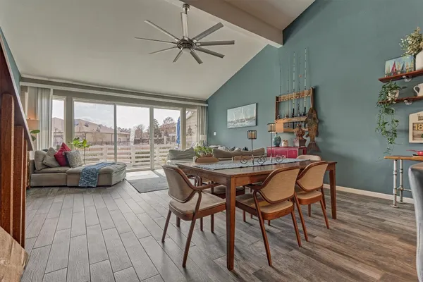 a dining area with furniture and wooden floor