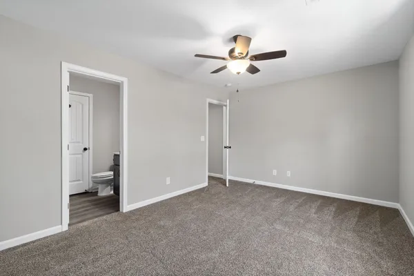 a view of an empty room and a bathroom