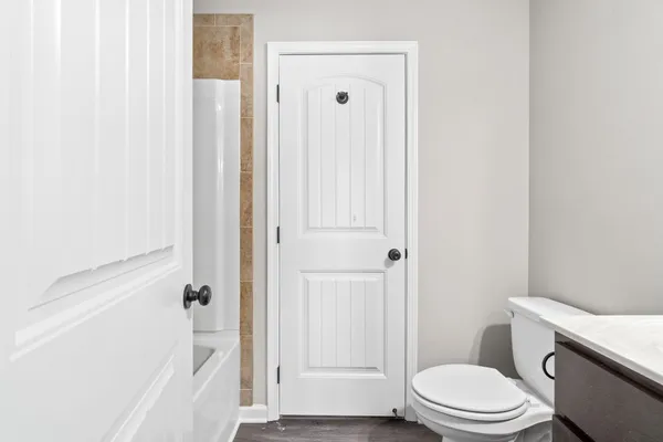 a bathroom with a toilet and a shower