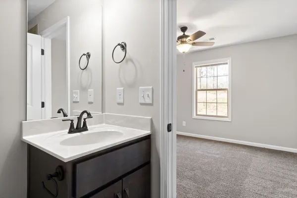 a bathroom with a sink a light fixture and a window