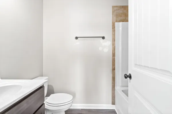 a bathroom with a white toilet and a shower