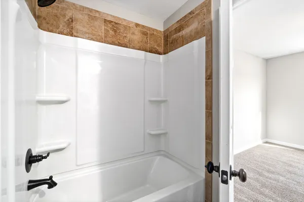 a bathroom with a bathtub and shower