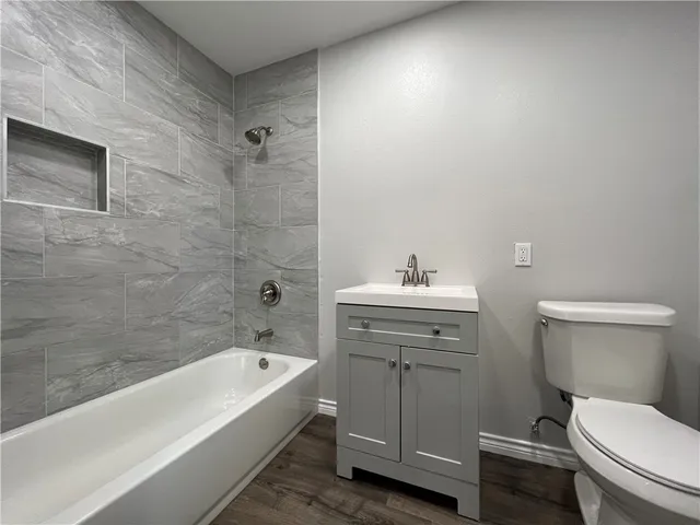 a bathroom with a sink a toilet and bathtub