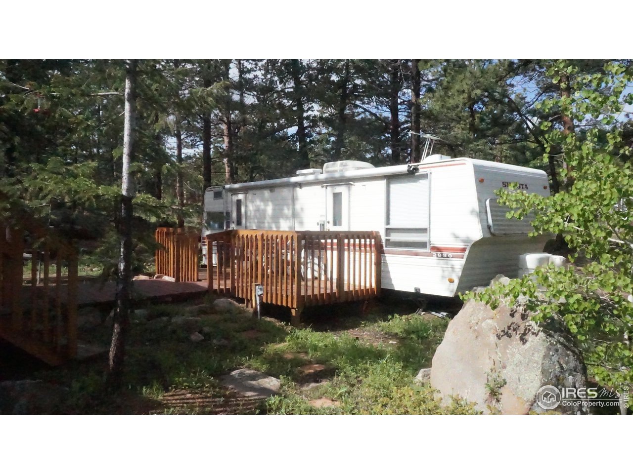 655 Nokomis Road Red Feather Lakes, CO 80545 - Photo 18 of 21 RV parking on property with power, septic hook-up and deck for up to a 29 ft trailer. (RV in photo not included)