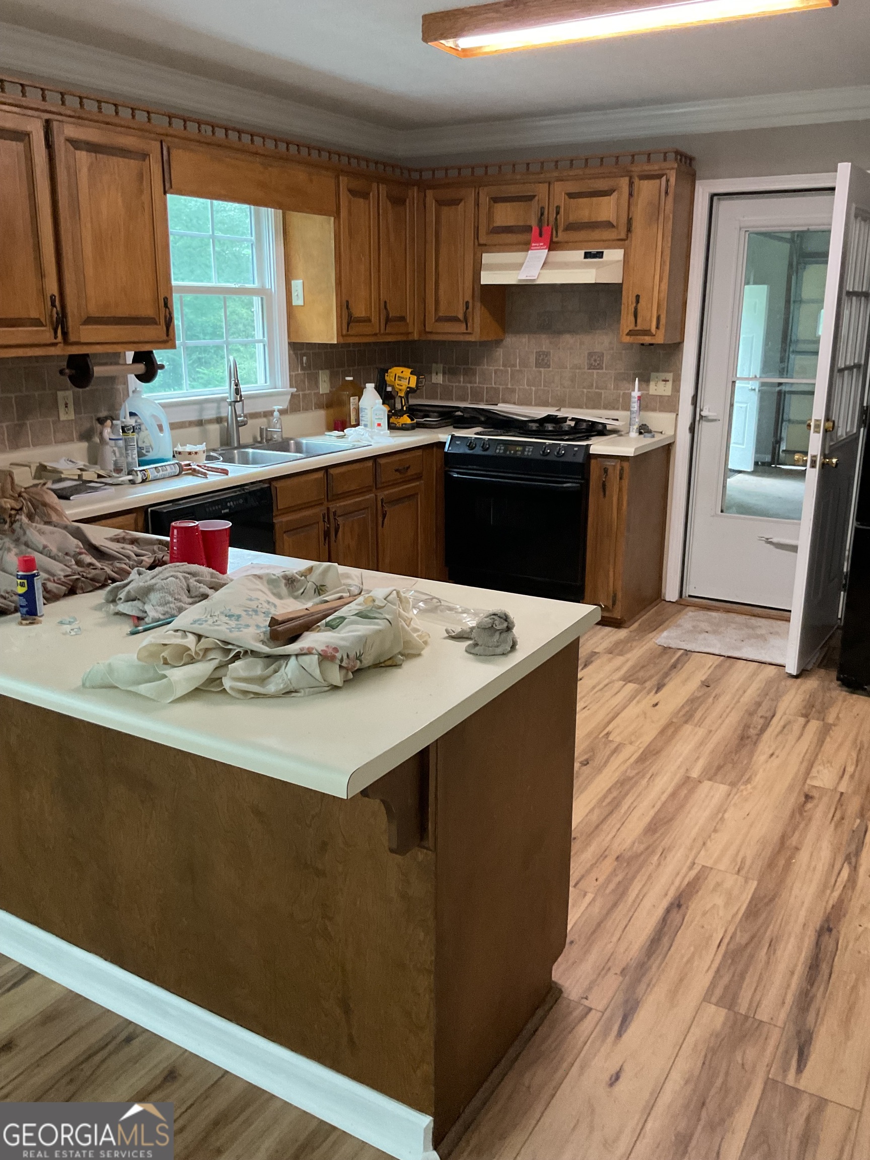 4800 Bethlehem Road Fairburn, GA 30213 - Photo 17 of 49 a kitchen with stainless steel appliances kitchen island granite countertop a sink stove and refrigerator
