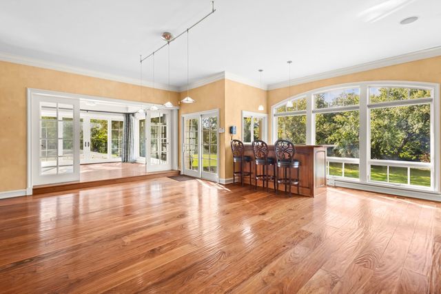 a view of a dining room with furniture window and wooden floor