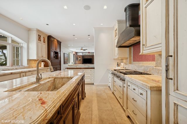 a kitchen with stainless steel appliances granite countertop a lot of counter space and a sink