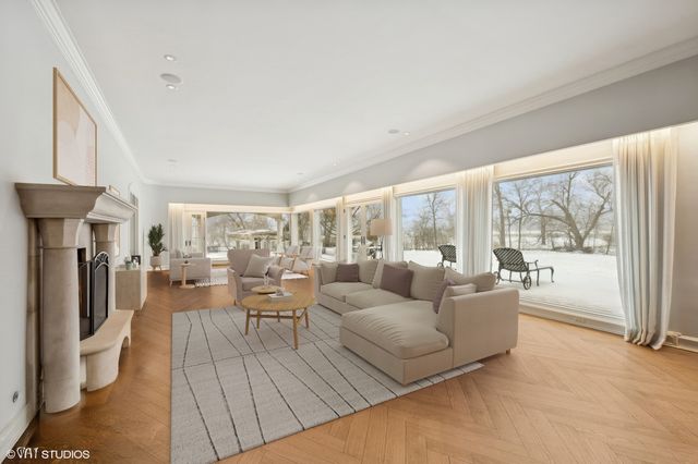 a living room with furniture and a floor to ceiling window